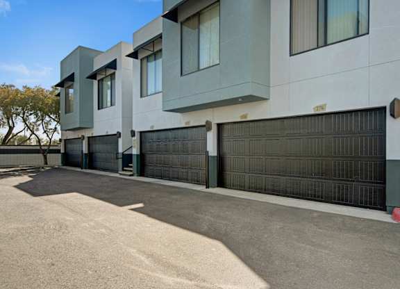 A modern building with a black gate in front.