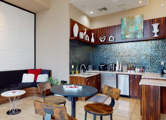 A kitchen with a table and chairs in the middle of it.
