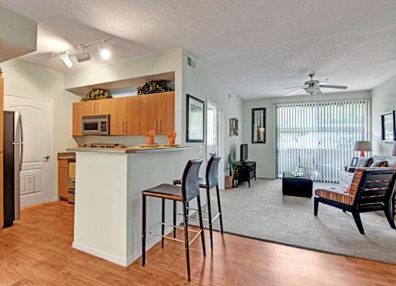 A kitchen with a white island and wooden cabinets.