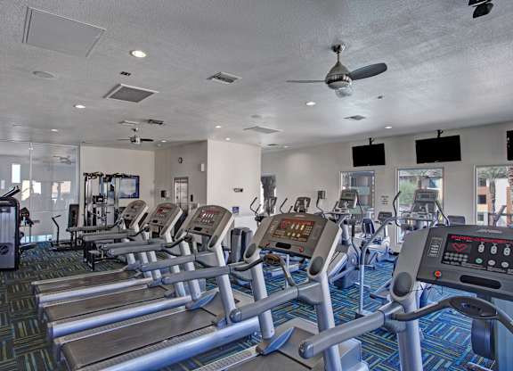 A gym with treadmills and other exercise equipment.