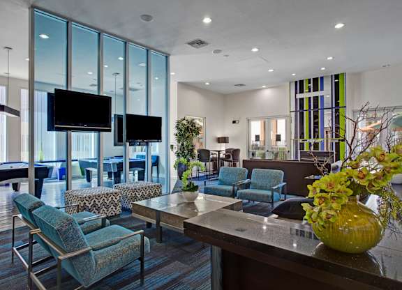 A modern living room with a pool table and a television.