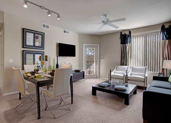 A living room with a dining table and chairs.