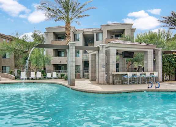 A modern house with a pool in the foreground.