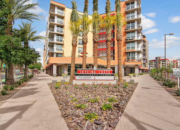 A building with a red and white sign that says Skyline Lofts.