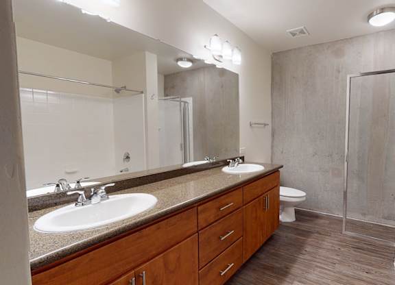 A bathroom with a sink, toilet, and shower.