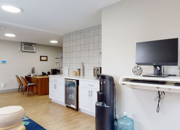 a room with a television and a kitchenette