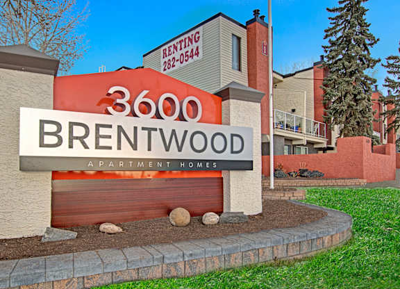 A sign for Brentwood Apartment Homes with a phone number for renting.