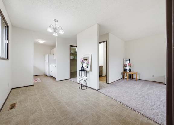 A room with a tiled floor and a chandelier hanging from the ceiling.