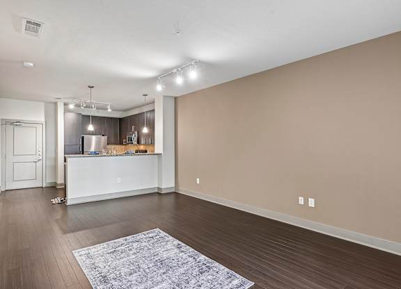 A spacious room with a kitchen island and bar area.