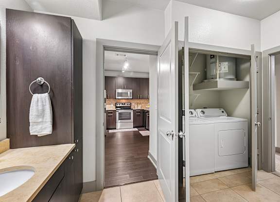 A modern kitchen with a wooden countertop and a white sink.