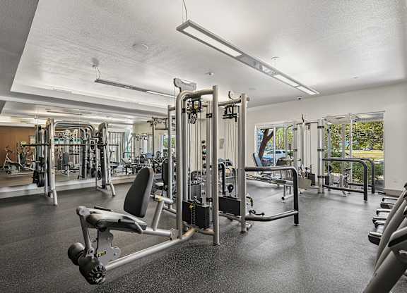 A gym with a variety of equipment including a leg press machine.