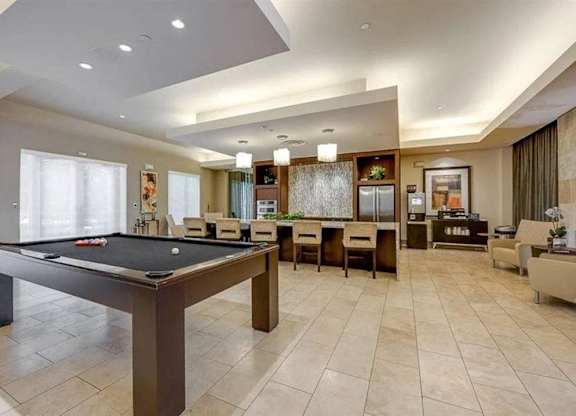 A room with a pool table and a couch.