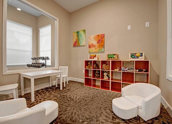 A room with a white chair, a white table, and a white bench.