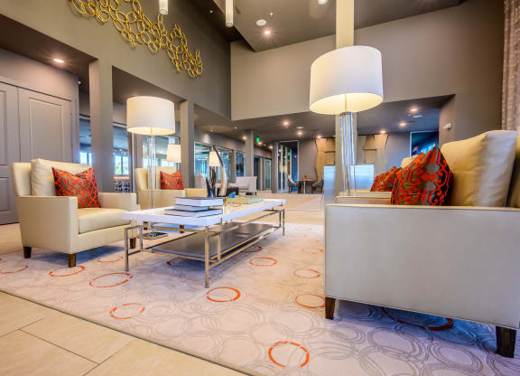 a living room with couches chairs and lamps and a rug