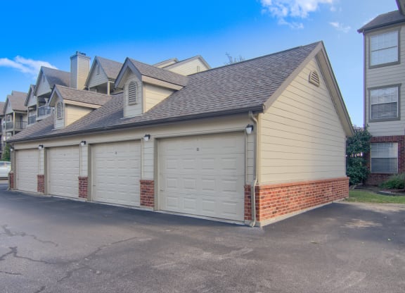a garage with three garages on the side of the house