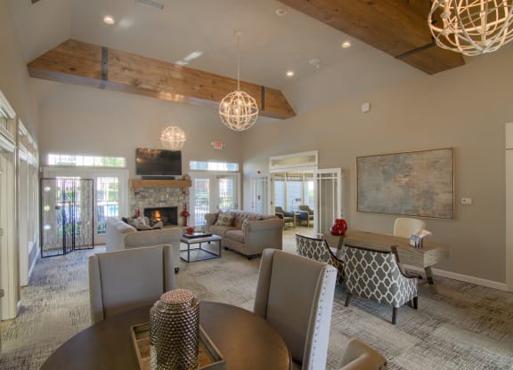 a large living room with a table and chairs