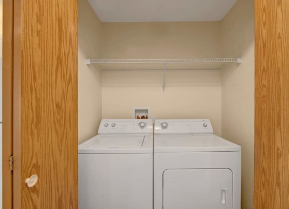 a washer and dryer in a room with a closet