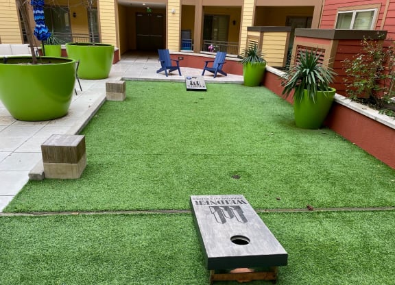 a yard with artificial turf and a memorial on it