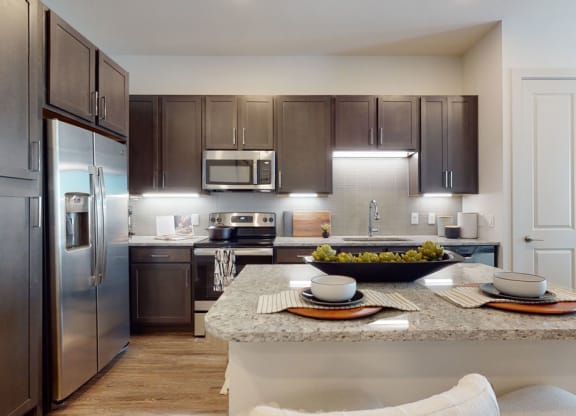 a kitchen with stainless steel appliances and a granite counter top