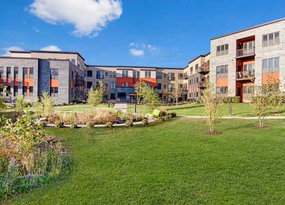 A grassy area in front of apartment buildings.