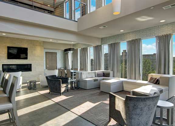 A modern living room with a flat screen TV and comfortable seating.