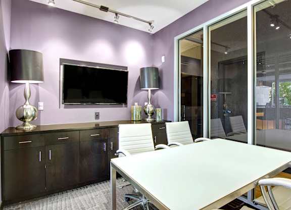A conference room with a long table and chairs.
