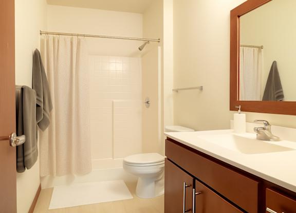 A bathroom with a toilet, sink, and shower.