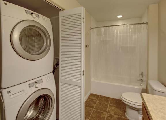 A white washer and dryer in a small laundry room.