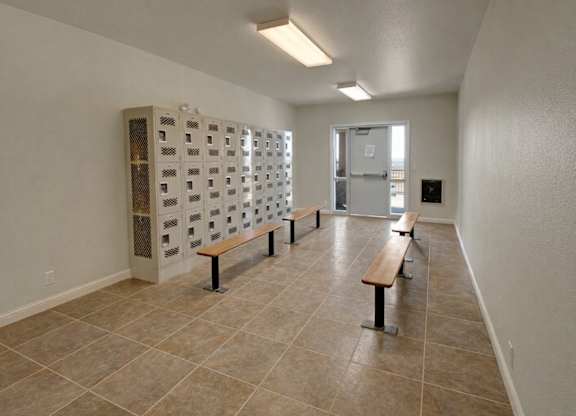 A room with a tiled floor and a row of benches.