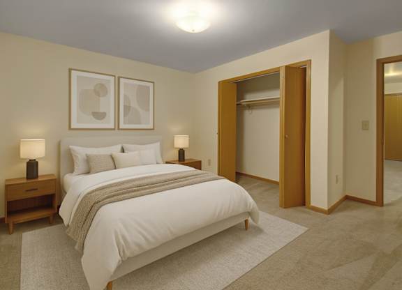 A bedroom with a large bed and two lamps.