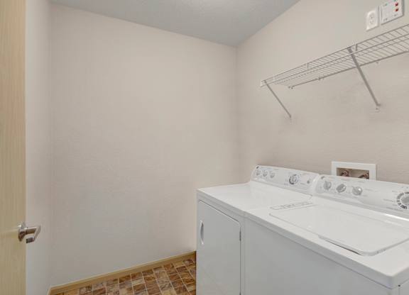 A white washer and dryer in a small laundry room.