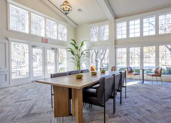 A conference room with a long table and chairs.
