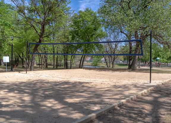 A sandy area with a goal post in the middle of it.