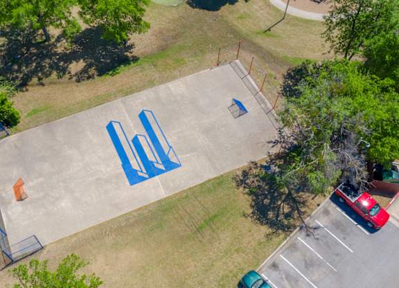 A basketball court with blue lines painted on it.
