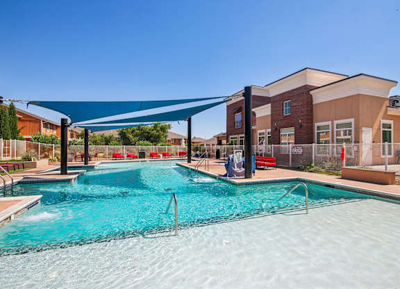 A large swimming pool with a blue tarp over it.