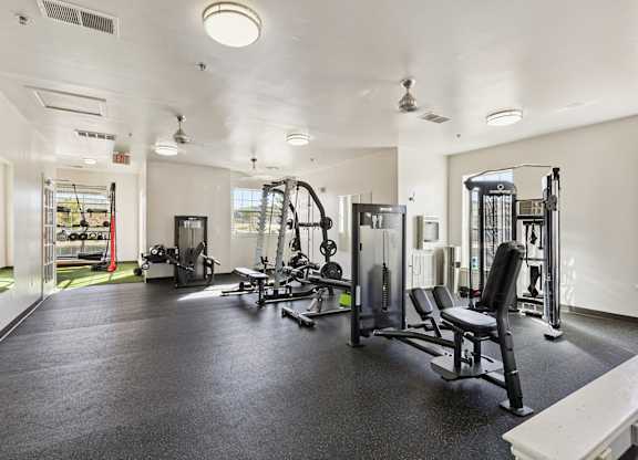 A spacious gym with various exercise equipment.