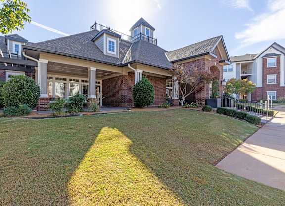 A house with a well-maintained lawn in front.