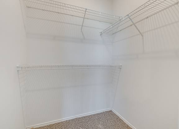 Empty white shelves in a room.