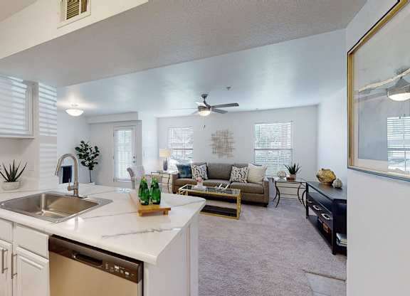 A modern kitchen with white cabinets and a large island.
