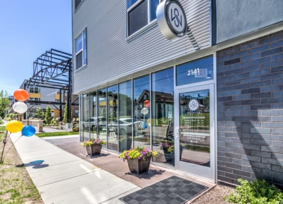 Stitchweld Apartments features a modern building exterior with large glass windows that reflect another building.