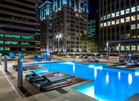 Nic on 5th Apartments in Minneapolis, Minnesota- Exterior night view of pool and recreational area
