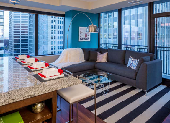 Nic on 5th Apartments in Minneapolis, Minnesota- Furnished large living room with floor to ceiling views of Downtown West Minneapolis