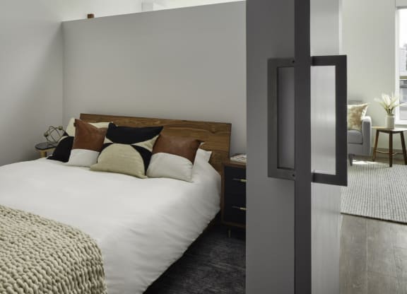 a bedroom with a large bed with pillows on it
