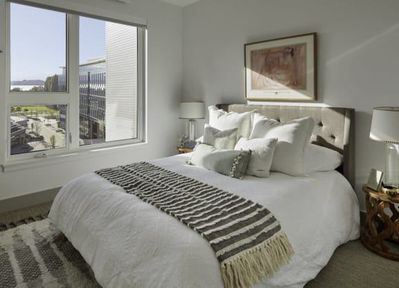a bedroom with a large bed and a window