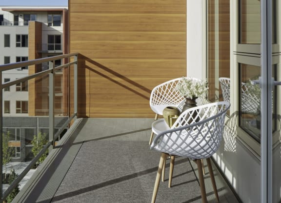 a balcony with a chair and a table on it