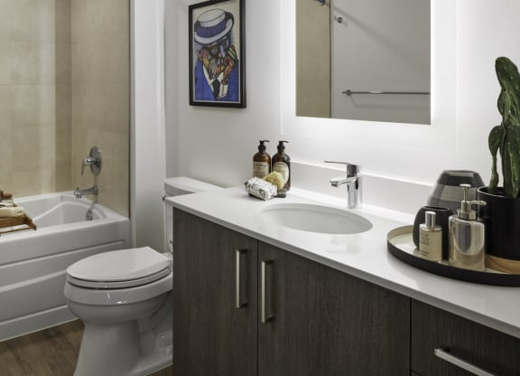 a bathroom with a sink toilet and bath tub