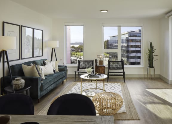 a living room with a couch and a table     and a window