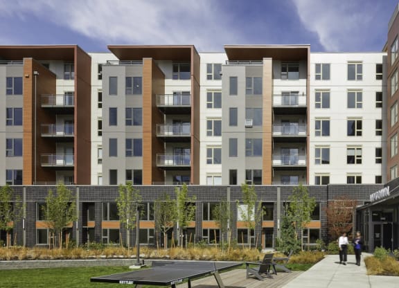 a rendering of an apartment building with a courtyard