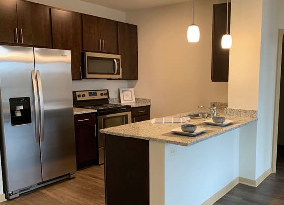 a kitchen with stainless steel appliances and a counter top