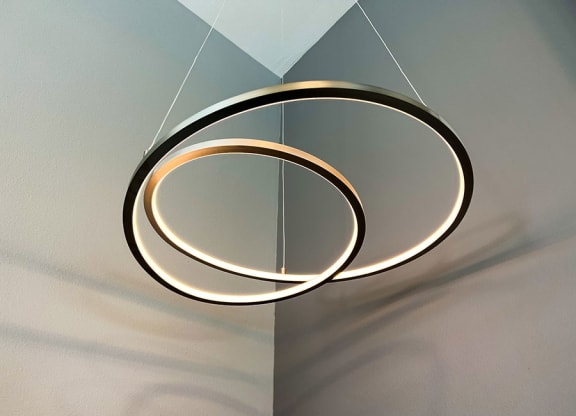 a circular light fixture hanging from a ceiling